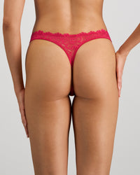 Model wears All Lacey Thong in JAZZY. On body back view