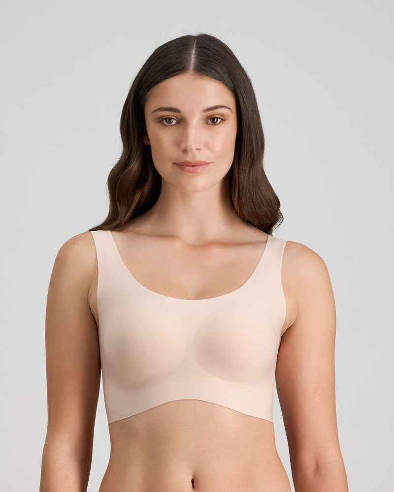 Model wears Comfit Collection Crop Top in LATTE. On body front view