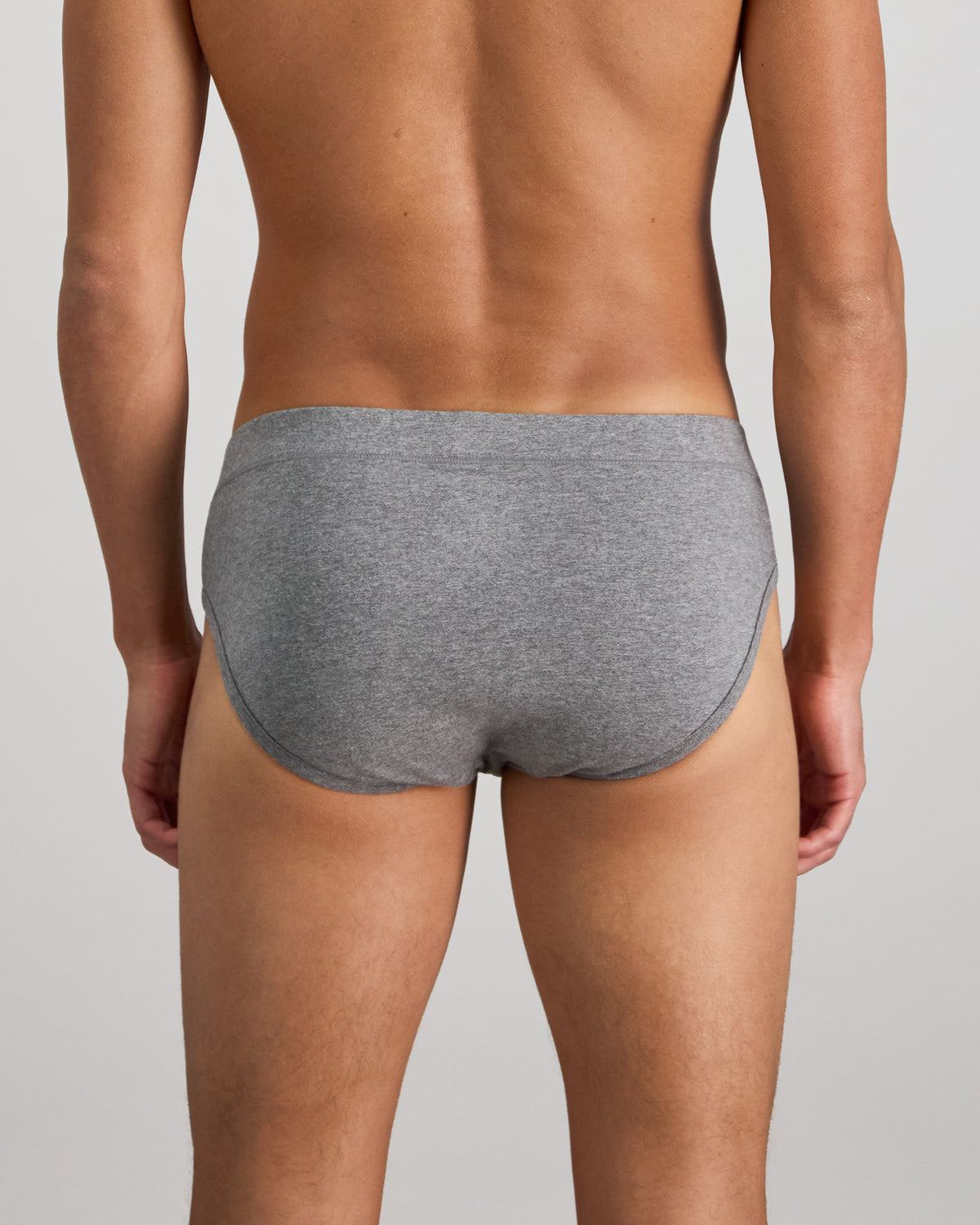 Model wears High Tech Cotton Mens Brief in GREY MARL. On body back view