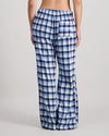 Model wears Cosy Flannel Long PJ Pant in BLUE CHECK. On body back view