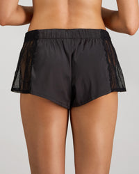 Model wears Lace Impact Short in BLACK. On body back view