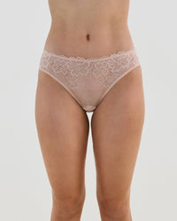 Model wears Lacey Bikini in LATTE. On body front view