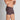 Model wears Cotton Stretch Mens Trunk in BLACK/RHUBARB STRIPE. On body side view