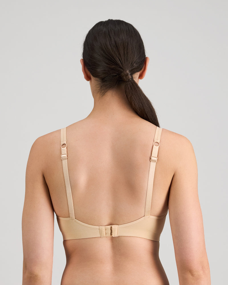 Model wears Simply Seamless Contour Bra in Nude. On body back view