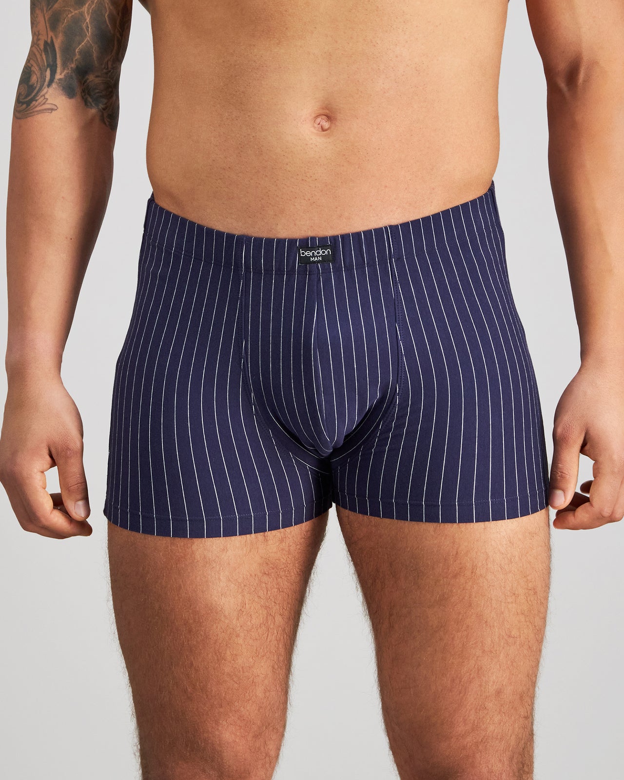 Model wears Cotton Stretch Mens Trunk in PEACOAT PINSTRIPE. On body front view