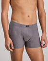 Model wears Cotton Stretch Mens Trunk in ASH PINSTRIPE. On body side view