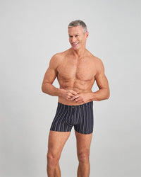 Model wears Cotton Stretch Mens Trunk in NAVY/WHITE. On body front view