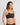 Model wears Simply Seamless Crop Top in BLACK. On body side view
