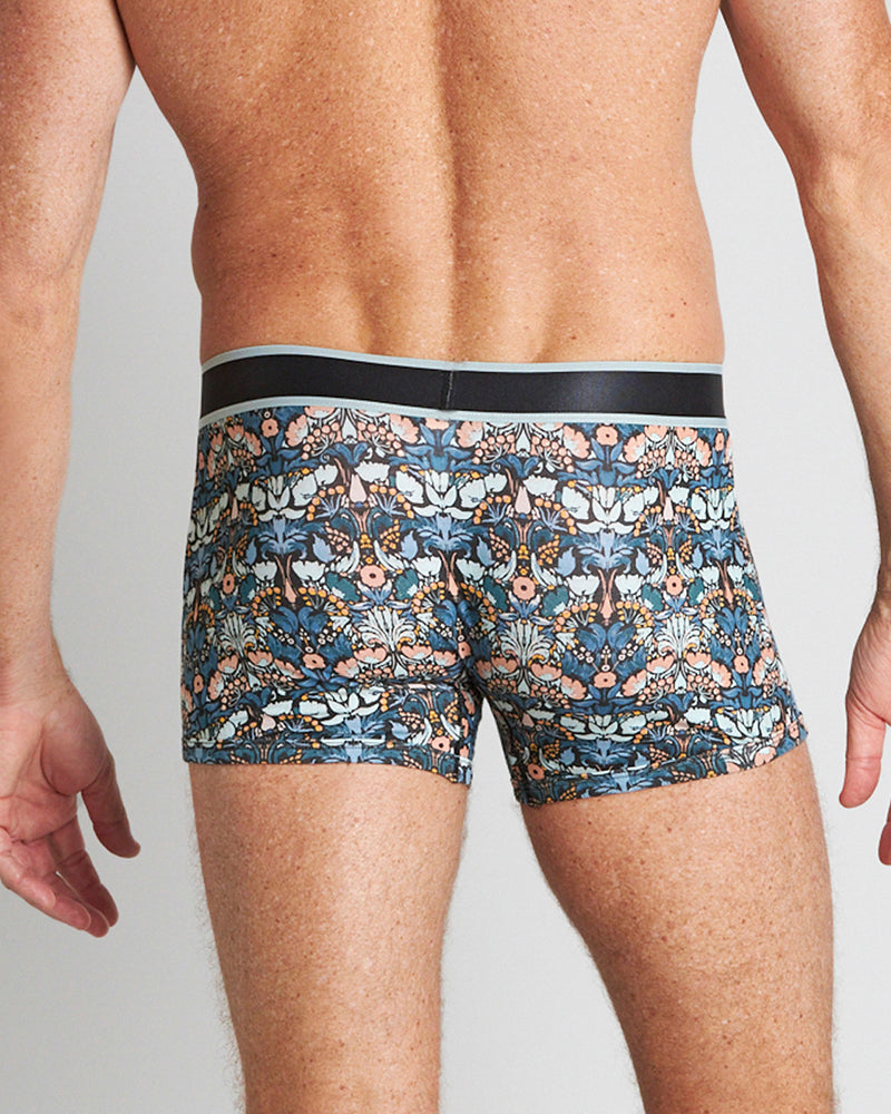 Model wears Retros Print Mens Trunk in TWISTED CLASSICS. On body back view