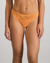 Model wears My Fit Underlayer Thong in TANGERINE. On body front view