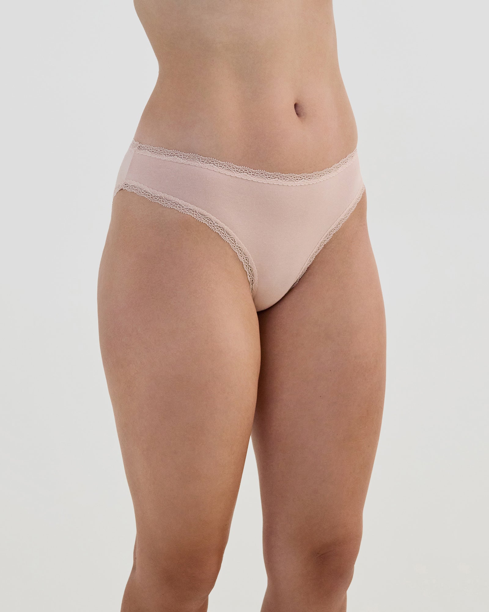 Model wears Stretch Cotton Bikini in LATTE. On body side view