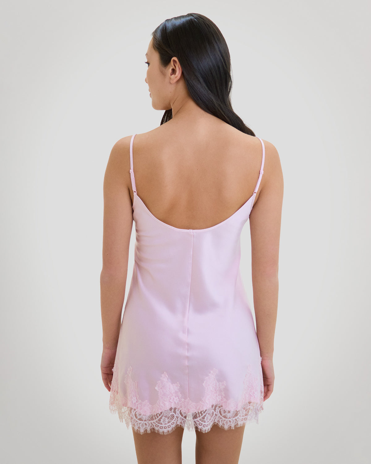 Model wears Sweet Indulgence Chemise in PALE LILAC. On body back view