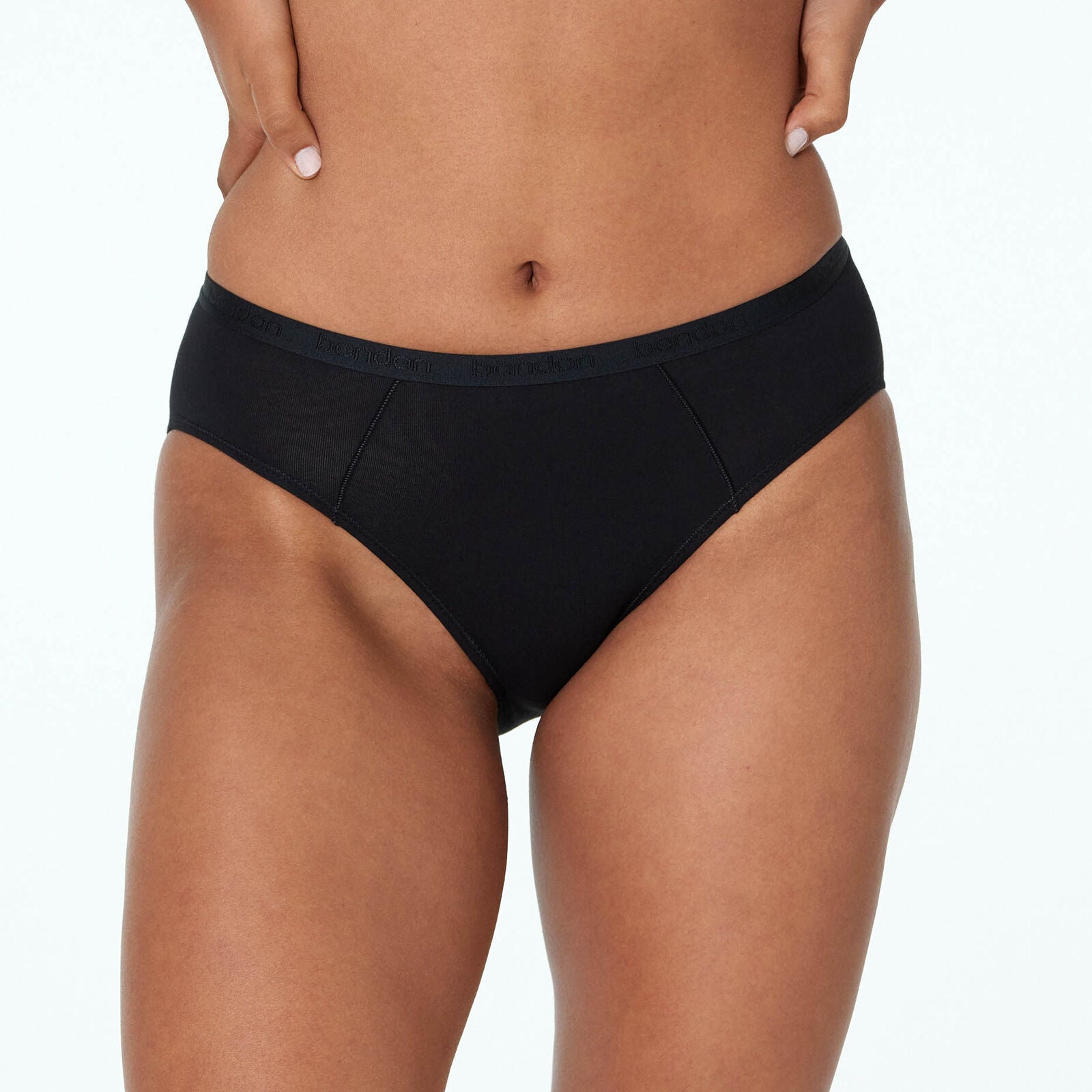 Model wears Body Cotton Bikini in BLACK. On body front view