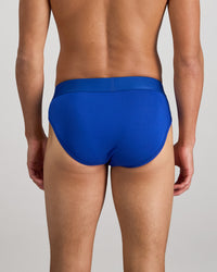Model wears Bamboo Mens Brief in Surf The Web. On body back view