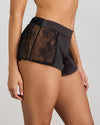 Model wears Lace Impact Short in BLACK. On body side view