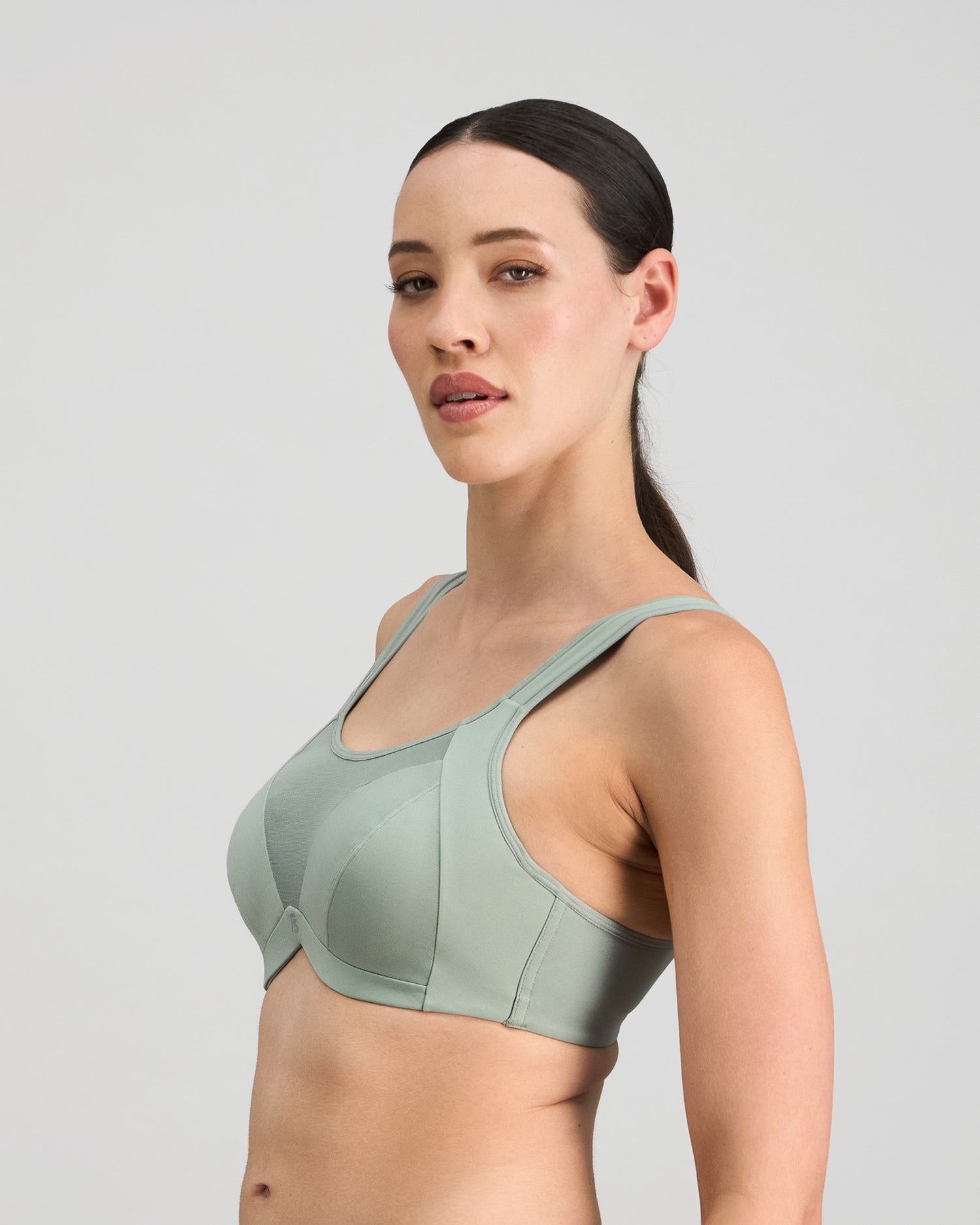 Model wears Power Underwire Bra in ICEBERG GREEN. On body side view