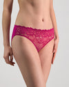 Model wears Lacey Bikini in FANTASY FUCHSIA. On body side view