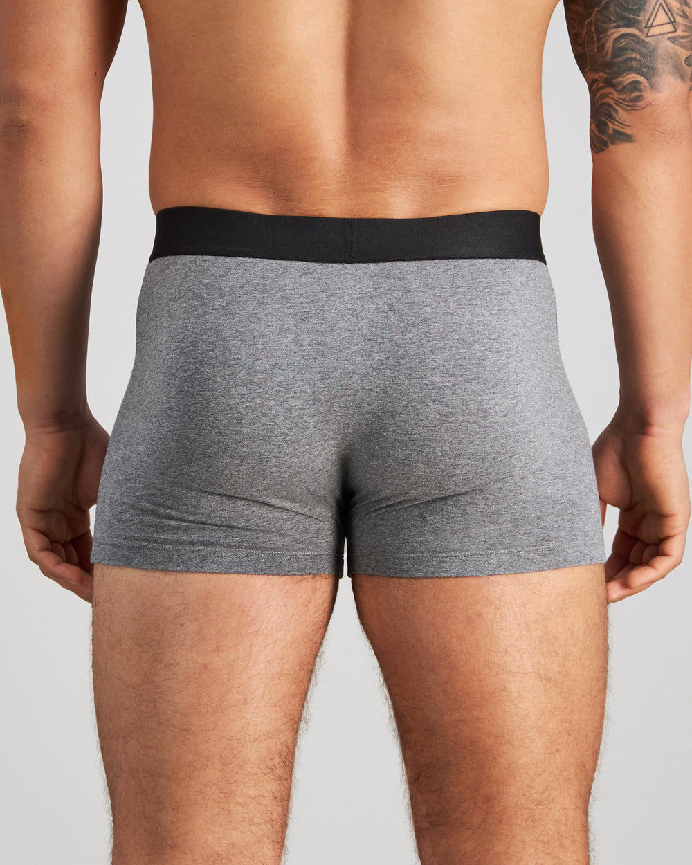 Model wears Everyday Essential Mens Trunk in GREY MARL. On body back view
