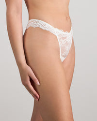 Model wears My Fit Lace Thong in WHITE. On body side view