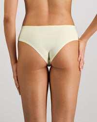Model wears Lacey Brazilian in TRANSPARENT YELLOW. On body back view