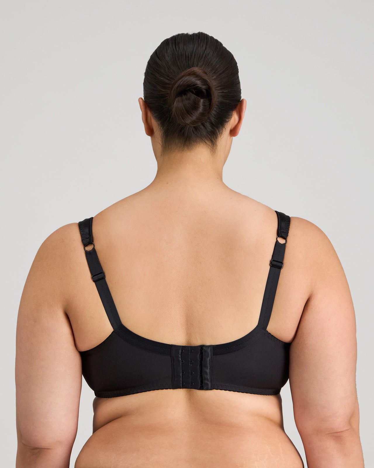 Model wears Charlotte Underwire Bra in BLACK. On body back view