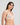 Model wears Sofia Underwire Bra in CAMEO. On body side view