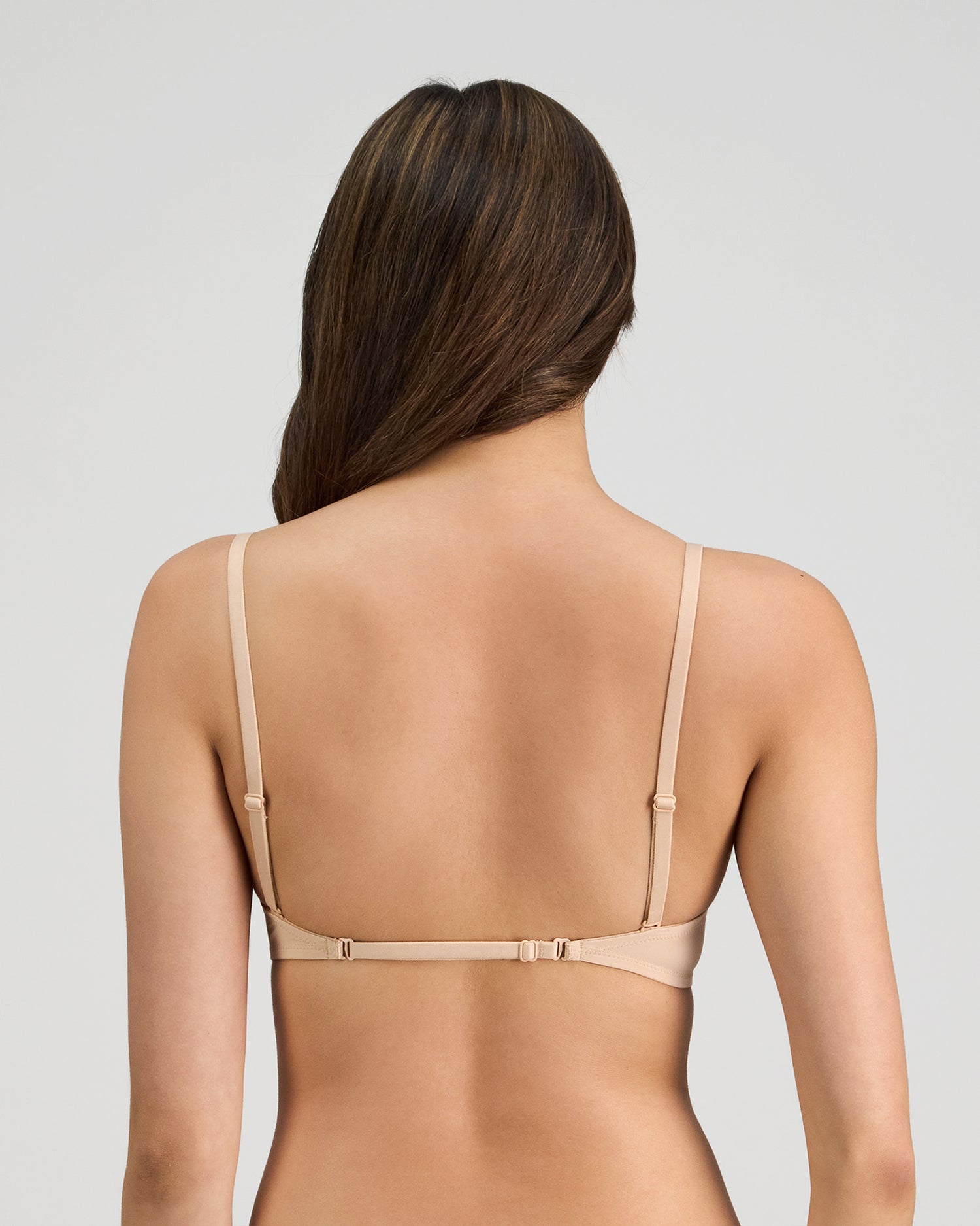 Model wears Infinity Multiway Convertible Bra in LATTE. On body back view