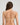 Model wears Infinity Multiway Convertible Bra in LATTE. On body back view