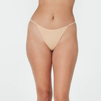 Model wears Clemence Thong in AMERICAN NUDE. On body front view
