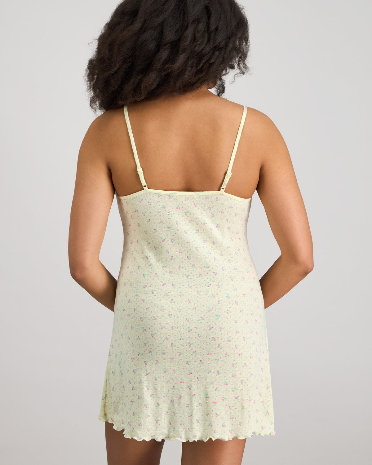 Model wears Smoothie Chemise in TRANSPARENT YELLOW. On body back view