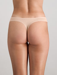 Model wears Extra-Ordinary Thong in LATTE. On body back view