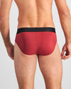 Model wears Everyday Essential Mens Brief in TIBETAN RED. On body back view