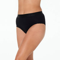 Model wears Cotton Logo Full Brief in BLACK. On body side view