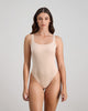 Model wears Extra-Ordinary Bodysuit in LATTE. On body front view