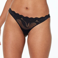 Model wears Sienna Siesta Thong in BLACK. On body front view