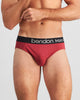 Model wears Everyday Essential Mens Brief in TIBETAN RED. On body front view