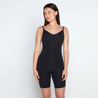 Model wears Medium Control Jumpsuit in BLACK. On body front view