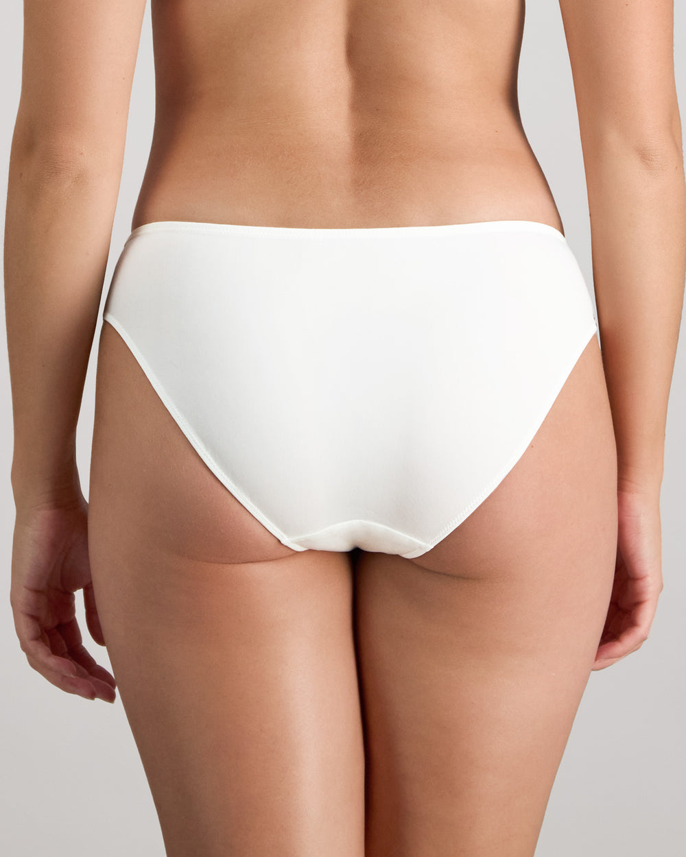 Model wears Renee Bikini in WHITE. On body back view