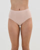 Model wears Seamless Soft Full Brief in LATTE. On body front view