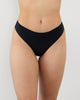 Model wears Au Naturel Thong in BLACK. On body front view