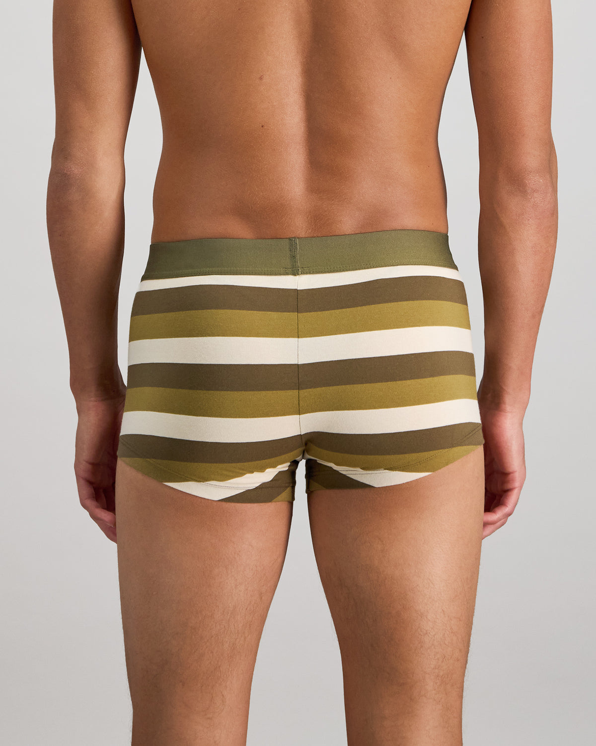 Model wears Rugby Stripe Mens Trunk in OLIVE/NUTRIA/OATMEAL. On body back view