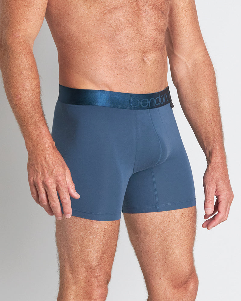 Model wears Bamboo Mens Trunk in BLUE WING TEAL. On body side view