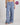 Model wears Cosy Flannel Long PJ Pant in BLUE CHECK. On body front view