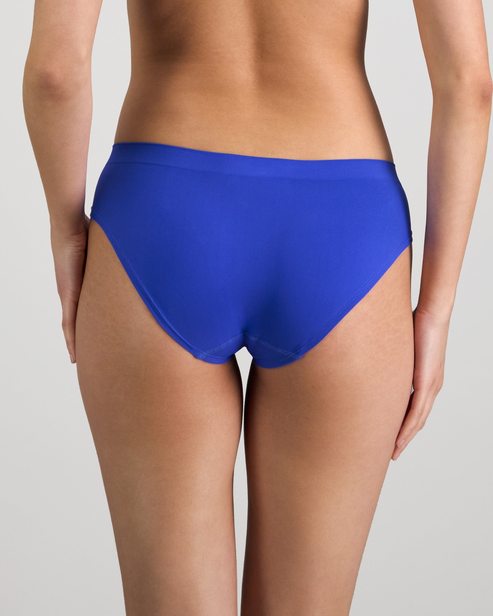 Model wears Seamless Soft Bikini in DAZZLING BLUE. On body back view