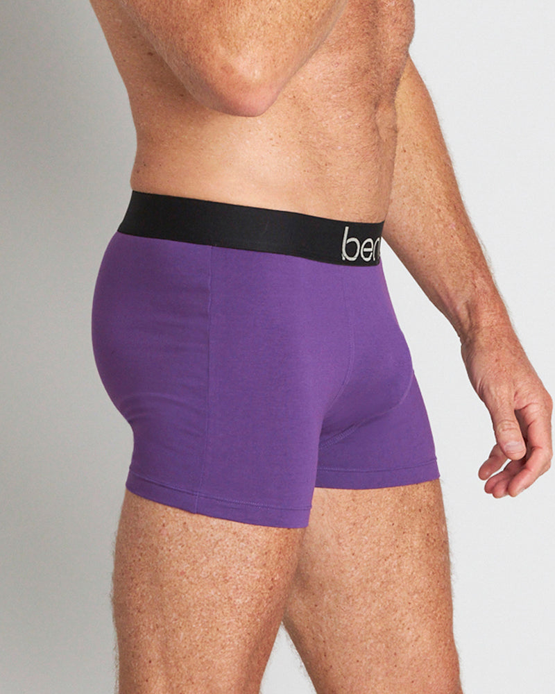Model wears Everyday Essential Mens Trunk in PURPLE MAGIC. On body side view