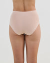 Model wears Seamless Soft Full Brief in LATTE. On body back view