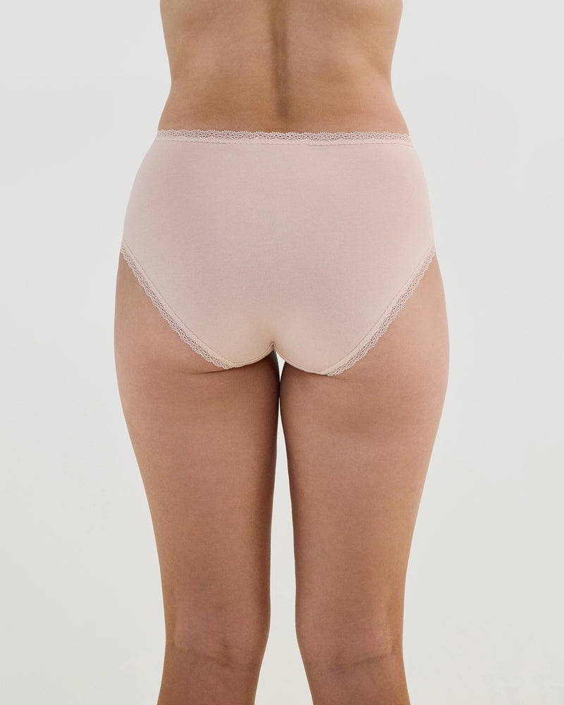 Model wears Stretch Cotton Full Brief in LATTE. On body back view