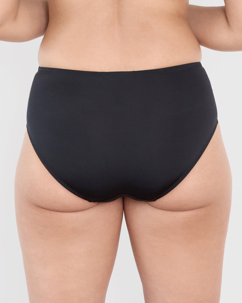 Model wears Castaway Midi in BLACK. On body back view