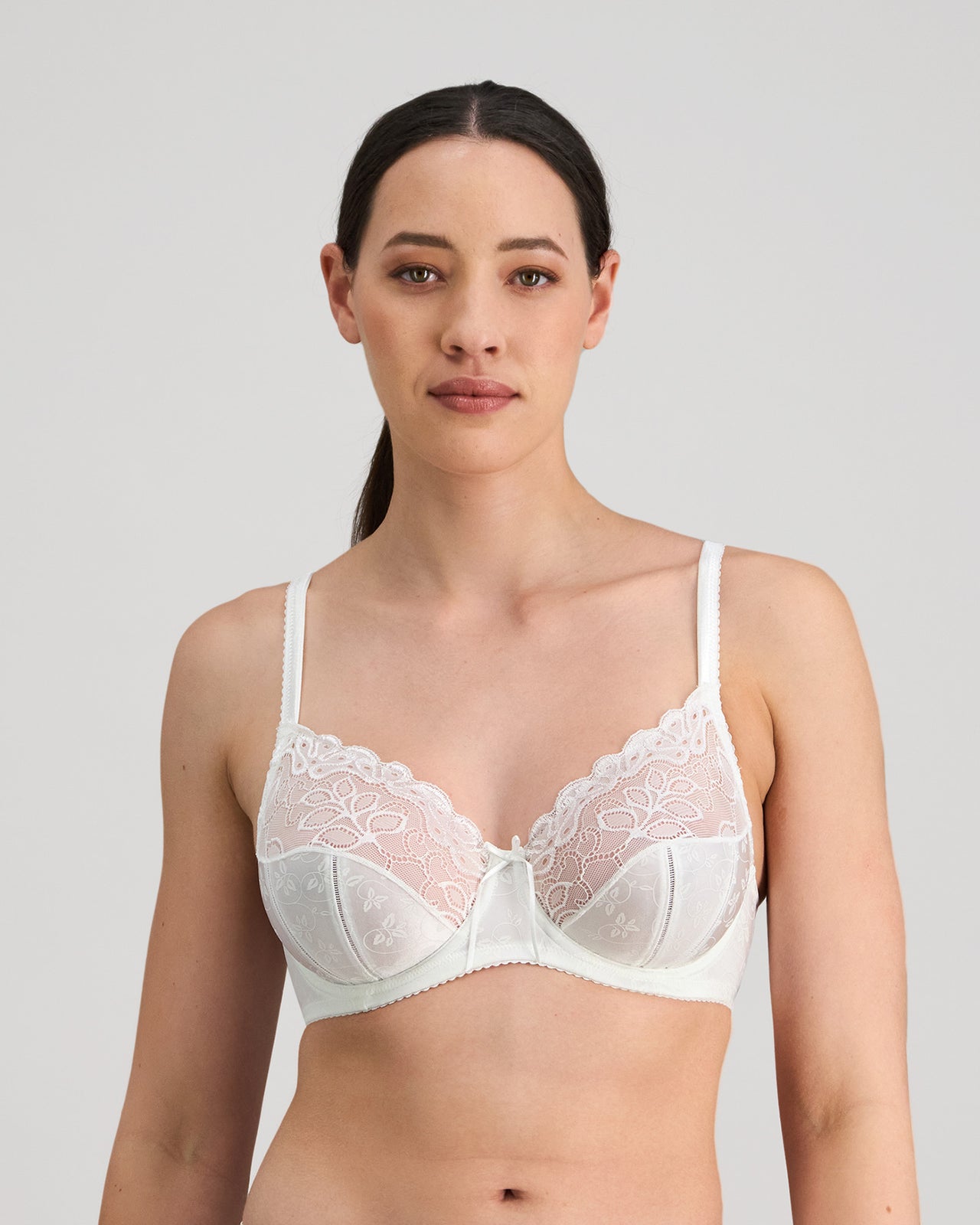 Model wears Yvette Underwire Bra in WHITE. On body front view