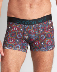 Model wears Retros Print Mens Trunk in GLOBAL TILE PRINT. On body front view